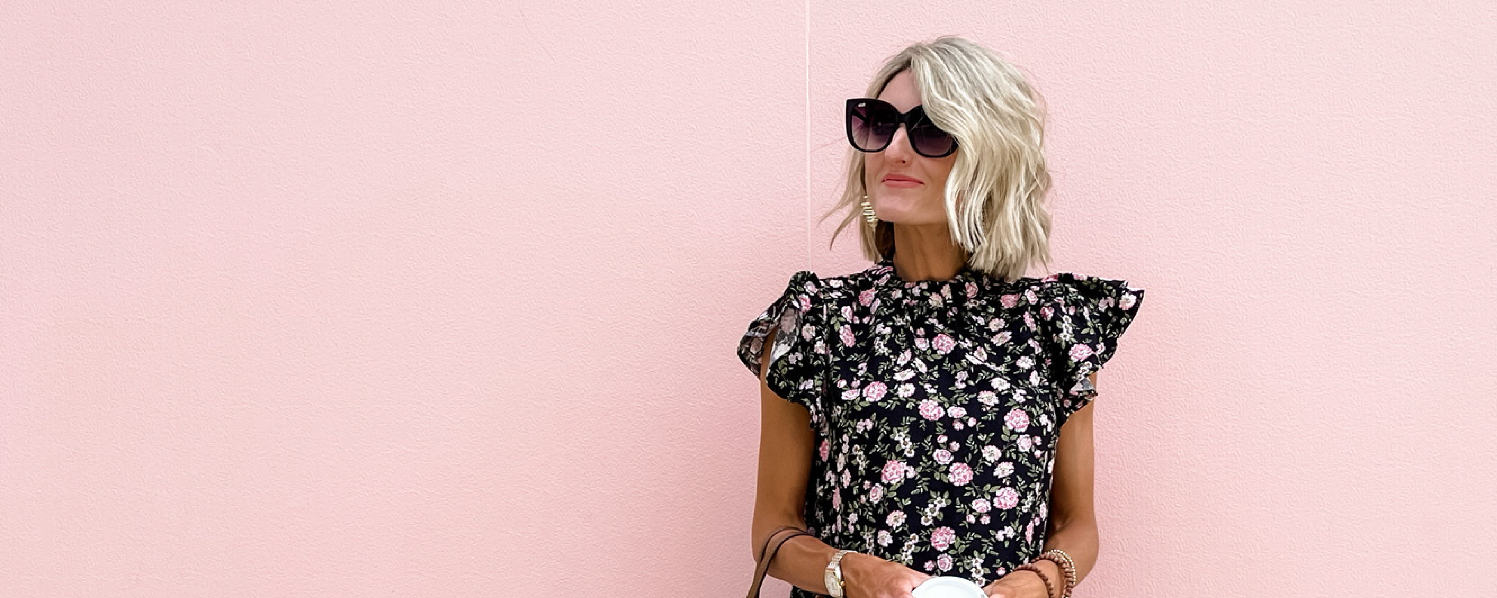 Creator standing against a pink backdrop